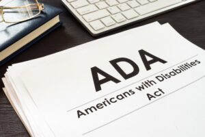 A close up of a thick document with a title page that says ADA Americans with Disabilities Act.